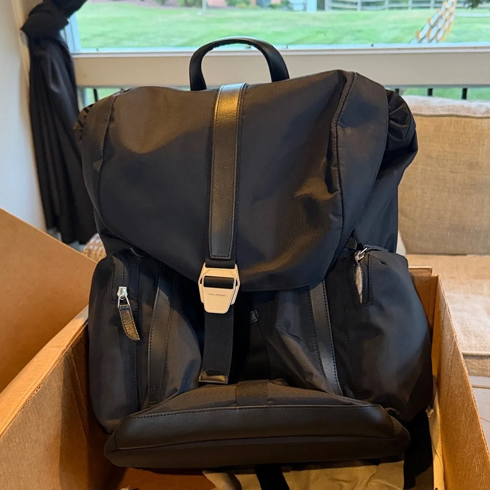 Brand New (original package). CARL FRIEDRIK Black men’s book bag. Never used.